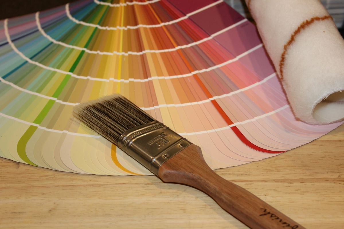 Paint colour fan deck and a brush