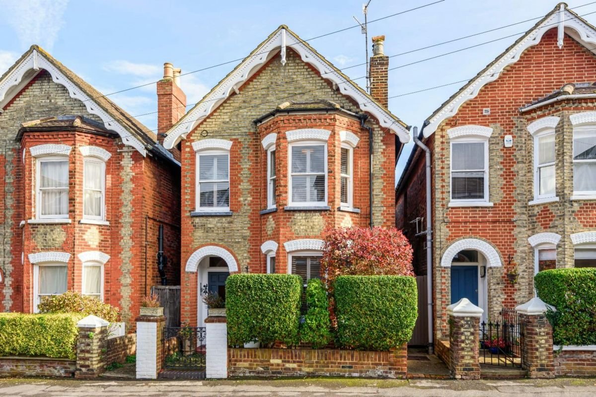 Pair of Edwardian semi-detached houses with red brick and white painted woodwork