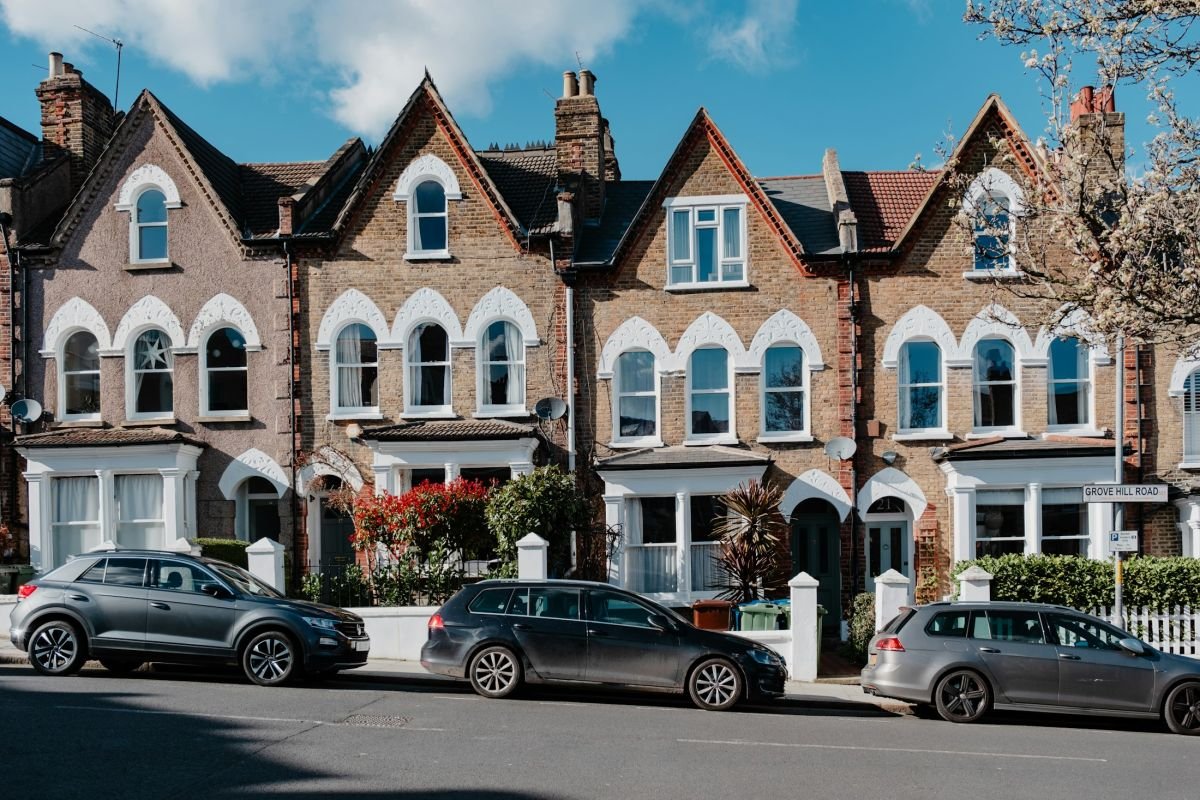 Row of Edwardian terraced houses with bay windows and painted render