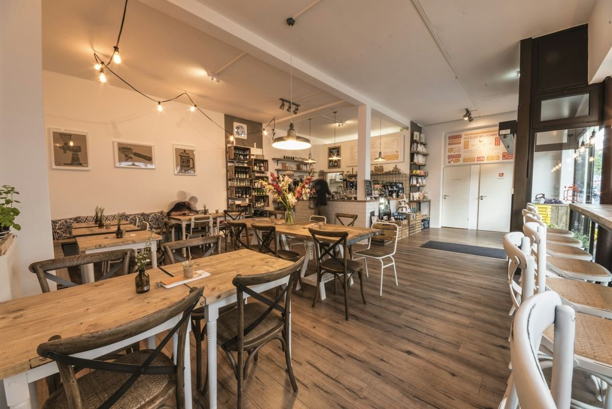 Light, freshly decorated cafe interior with wooden tables