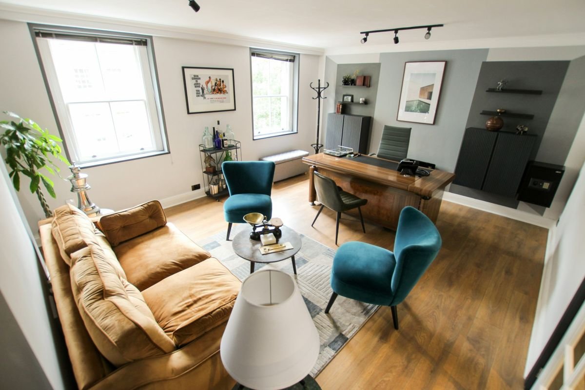 London flat with sash windows, pale walls and a velvet sofa