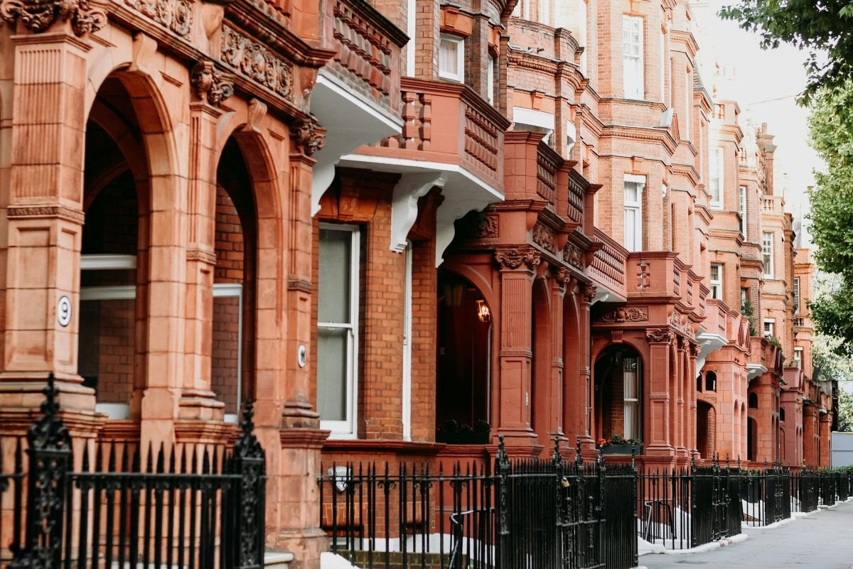 Red-brick London mansion block with white painted window surrounds