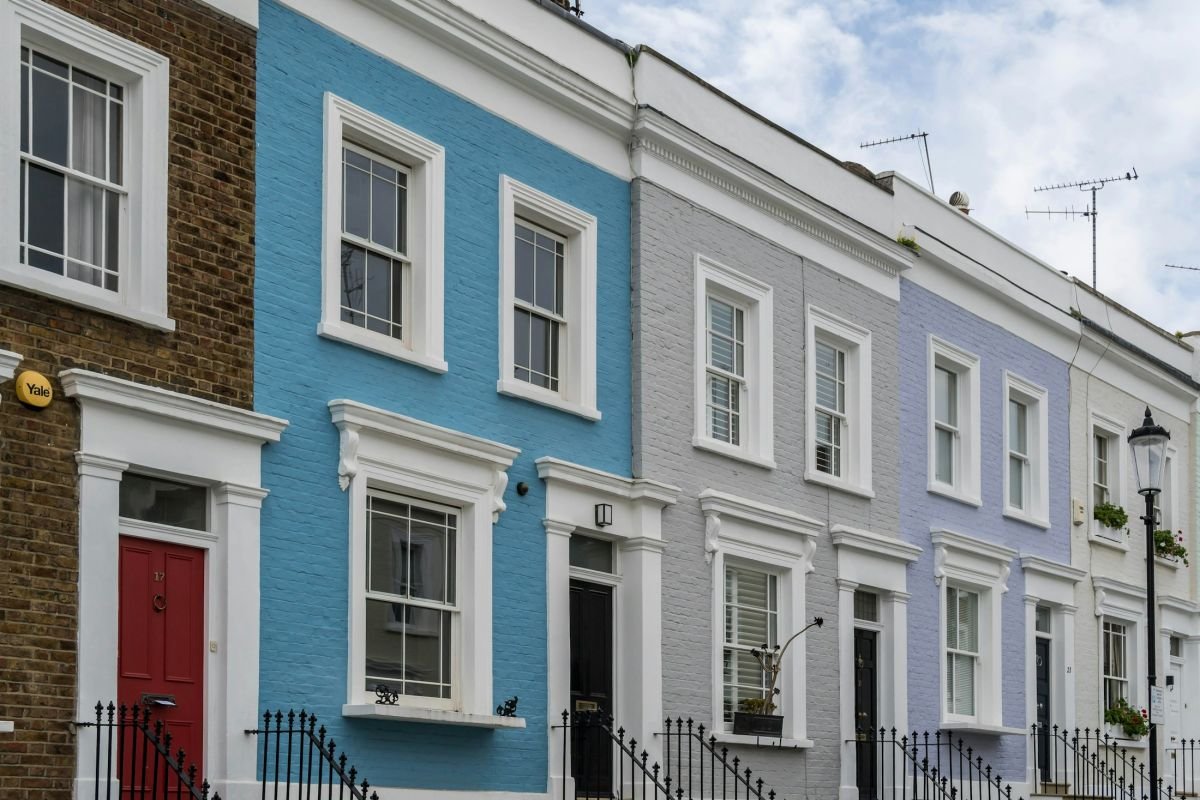 Painted London terrace in soft blues and greys with a red front door