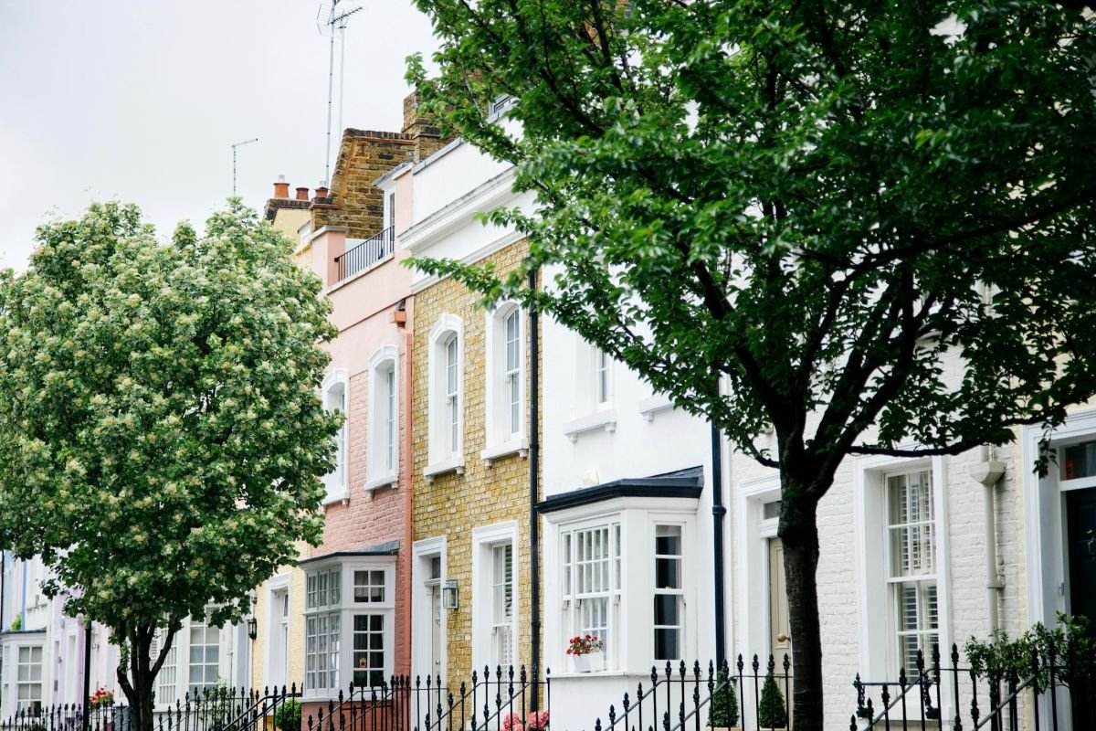 White stucco London terrace behind trees