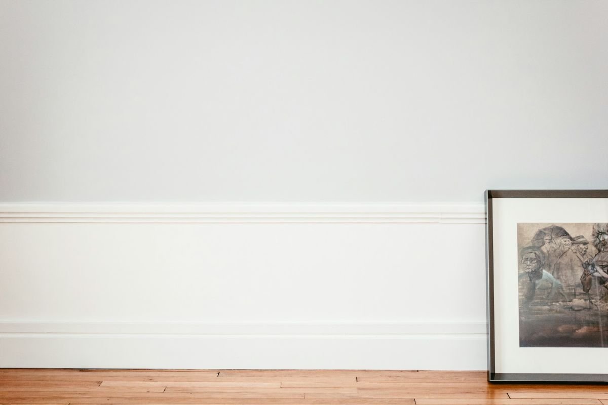 White painted dado panelling and skirting with a framed print